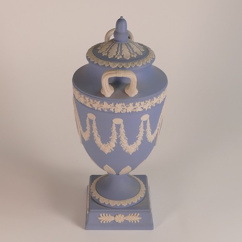 1387 - Wedgwood, blue Jasperware twin handled lidded urn. acorn finial moulded lid. Impressed 'Wedgwood' ma... 