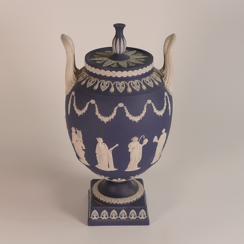 1388 - Wedgwood, dark blue Jasperware two handled urn & cover, classical relief scene to body. Impressed 'W... 