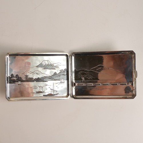 1421 - .950, Japanese export Niello Silver cigarette case. Decorated with cloud obscured Mt. Fuji above a f... 