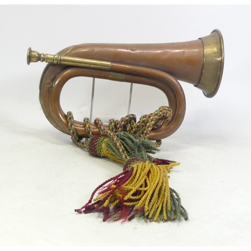 242 - Brass and Copper Bugle with red, yellow and green knotted rope.