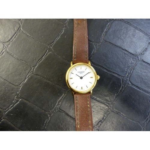 766 - Tissot gold plated wrist watch on a brown leather strap, SKK-JA-12829.