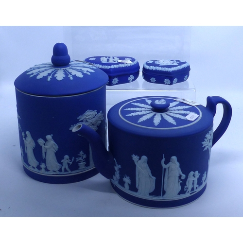 213 - Four pieces of Wedgwood blue dip jasper ware: teapot, biscuit barrell and two trinket boxes, height ... 