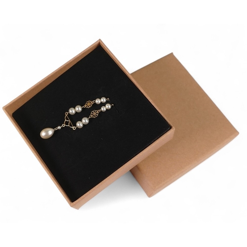 713 - 9ct gold pearl set pendant and chain, 4.1g.