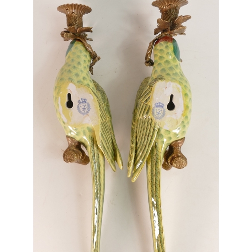 38 - A pair of ornate porcelain parrot wall sconce with metal bronze effect candlestick mounts. 48cm tall... 