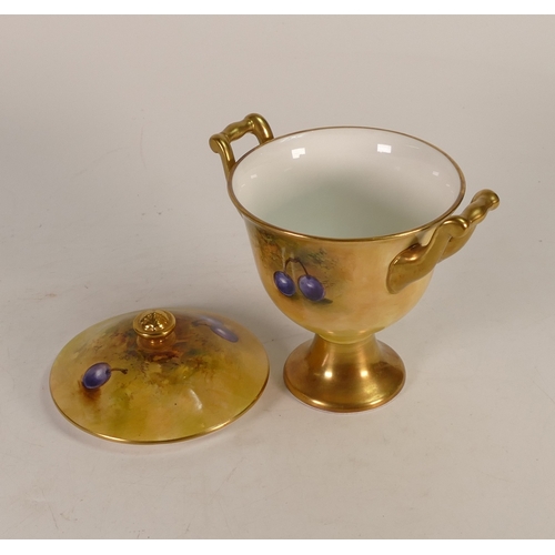 148 - Coalport Hand painted footed lidded Urn with decorative gilt handles depicting a Fruit design with a... 