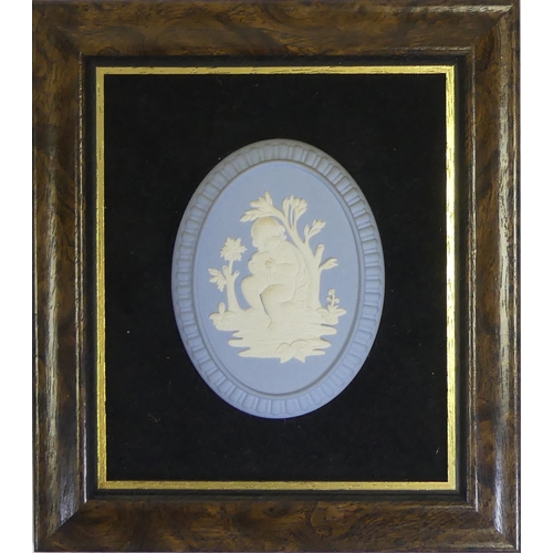 624 - Wedgwood Powder Blue Jasperware oval cameo depicting a Cherub, mounted on a black velvet style backg... 