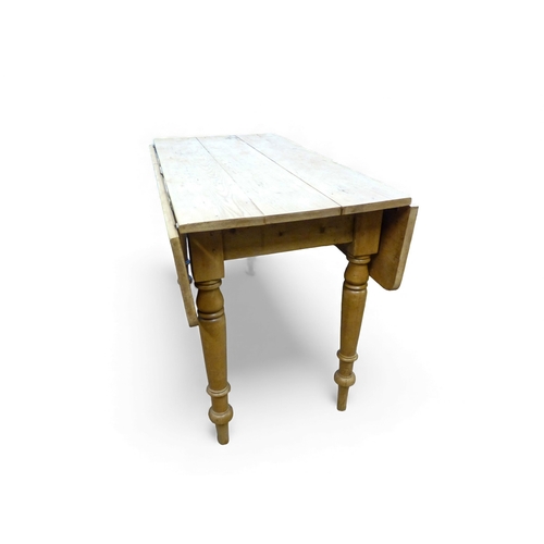655 - Pine farmhouse drop leaf plank top kitchen table with turned legs. H74cm x W106cm