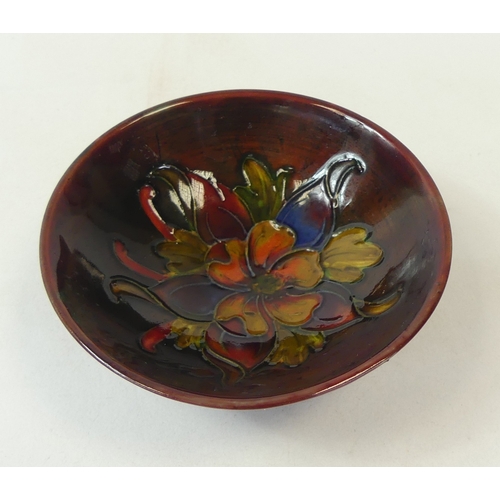 133 - Moorcroft Flambe 'Columbine' small footed Bowl, designed by Walter Moorcroft. 10cm dia
