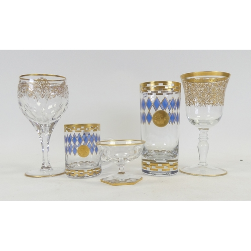 597 - De Lamerie, heavily gilt decorated wine glasses, cocktail glass, glass teacup and tumbler with a blu... 