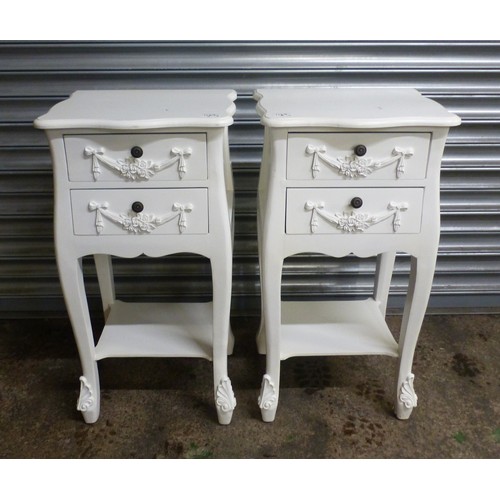 676 - A pair of modern, painted white 2-drawer bedside tables, with lower tier shelf to each, swag and bow... 
