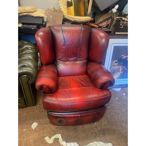 664 - Ox blood red leather reclining armchair.