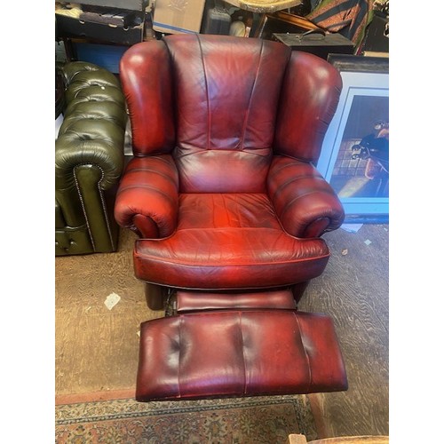 664 - Ox blood red leather reclining armchair.