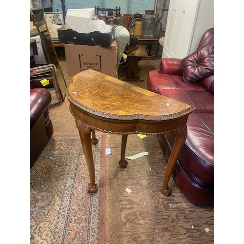 660 - Burr walnut console table that converts to a games/card table, raised on ball and claw feet, card an... 