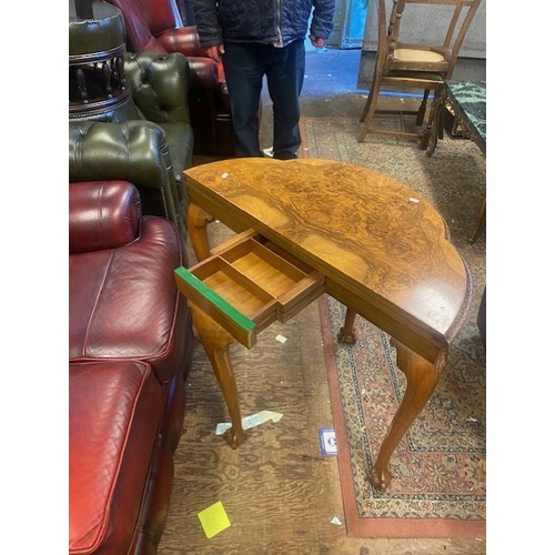 660 - Burr walnut console table that converts to a games/card table, raised on ball and claw feet, card an... 