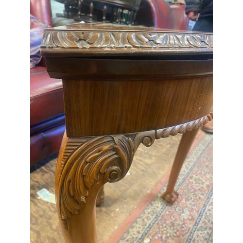660 - Burr walnut console table that converts to a games/card table, raised on ball and claw feet, card an... 
