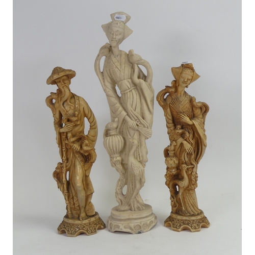 99 - A pair of Chinese-style carved resin figures depicting a man and a woman in traditional dress with b... 