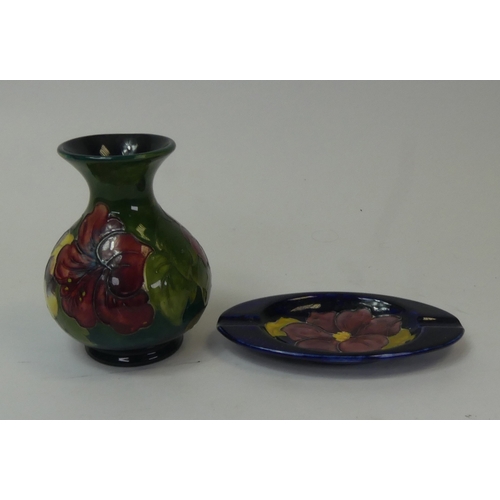 89 - Moorcroft Hibiscus pattern vase on green ground, together with Hibiscus dish on dark blue ground. (H... 