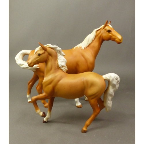 118 - Two Beswick palomino matt horses, a Swishtail and a Prancing Arab (2).