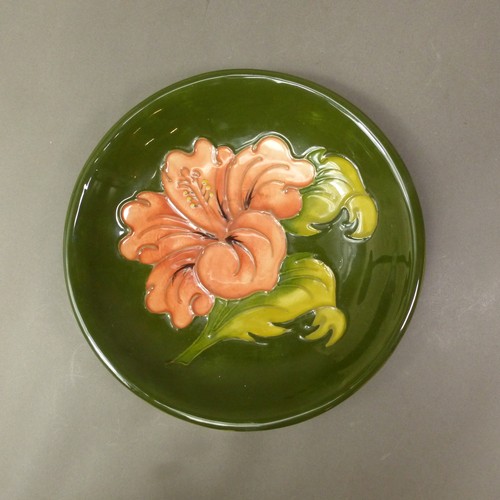 90 - Moorcroft Hibiscus design on green ground dish. (D: 8.5cm)