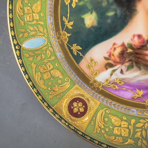A Royal Vienna plate with a green and gilt border, with centre ...