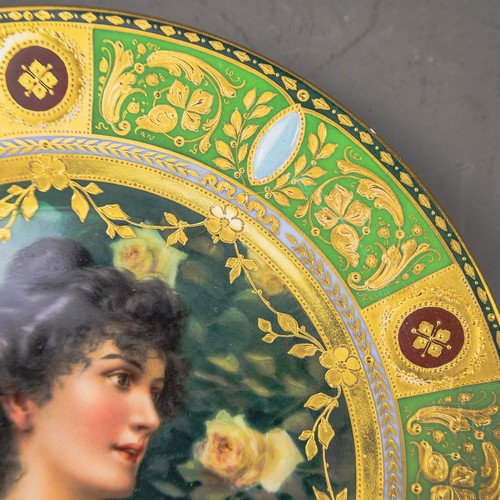 A Royal Vienna plate with a green and gilt border, with centre ...