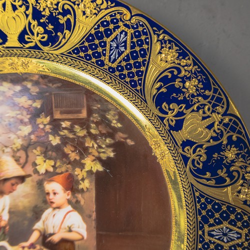 A Royal Vienna plate with a cobalt blue and gilt border, with centre ...