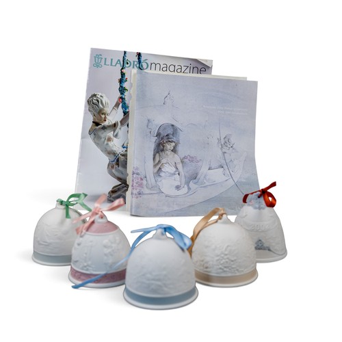 A group of five Lladro bells with ribbons, various embossed deigns ...