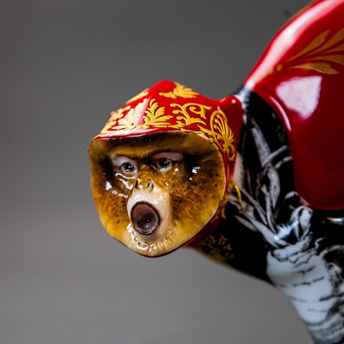 Alex Hooper for Minton, A gilded monkey uniquely decorated with red ...