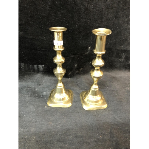 103 - Pair of brass candlesticks 21cm high