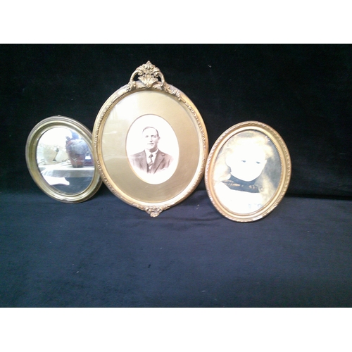 31 - Two oval gilt framed portraits & oval brass framed mirror