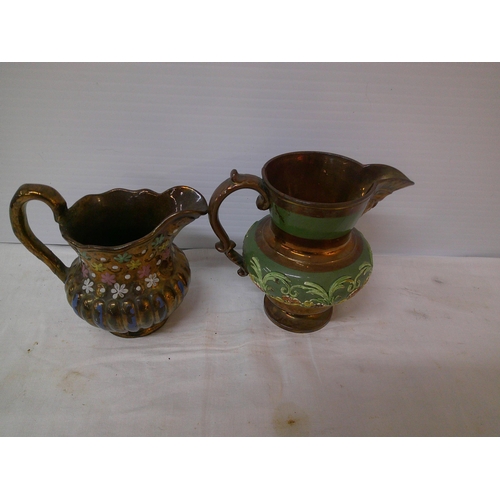 115 - Two brown lustre jugs largest 15cmH