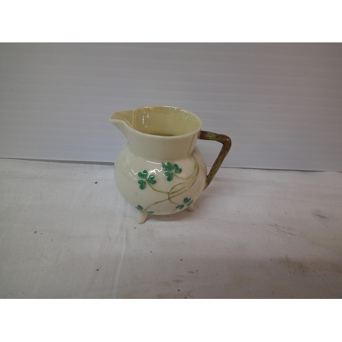 76 - A 2nd period Belleek shamrock jug 8cmH