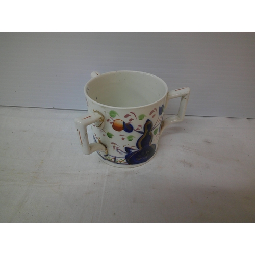 82 - A three handled pottery mug 10cmH