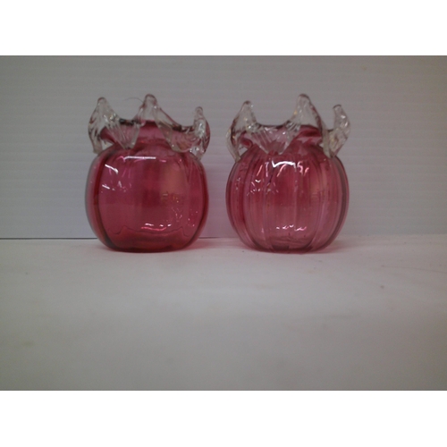 179 - A pair of ruby glass ribbon pots - 10cmH