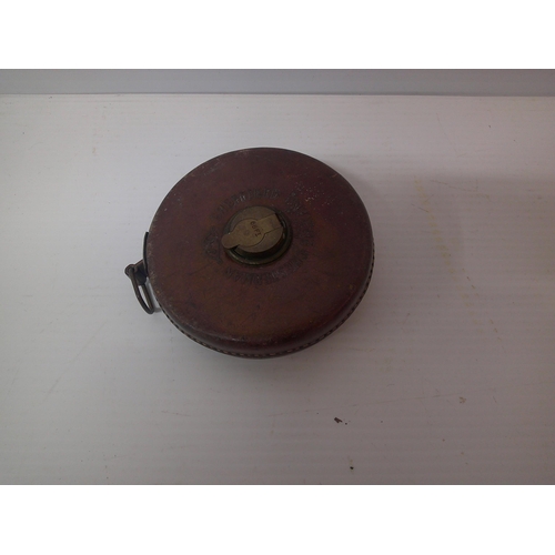 241 - A leather bound tape measure - 66ft