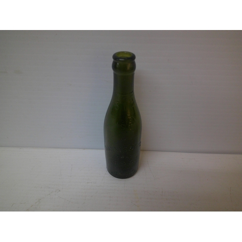 254 - A green glass bottle Downes & Sons, Ennis, 19.5cmH