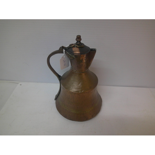 255 - A copper and brass jug - 29cmH