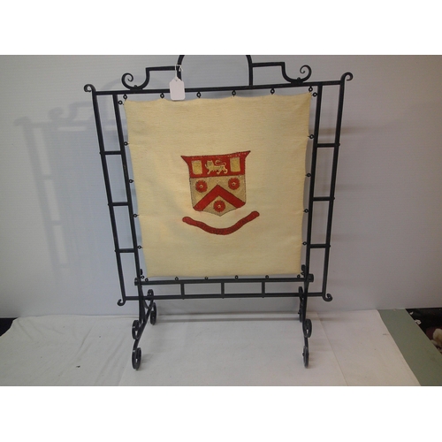 296 - A large metal framed fire screen with heraldic shield - 87cmH x 66cmW