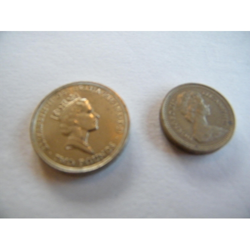 208 - A 1986 thistle two-pound coin along with a 1983 one-pound coin