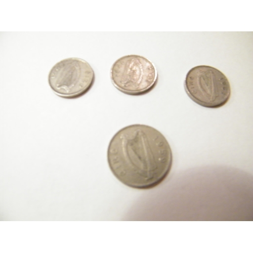 214 - One pre-decimal sixpence depicting a dog and three 3d coins depicting a hare