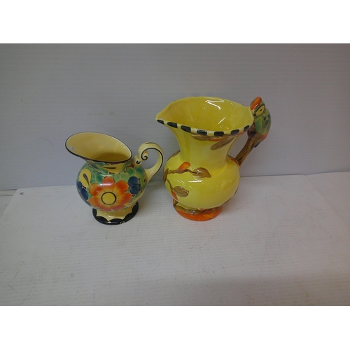 89 - Two coloured pottery jugs - 19cmH largest