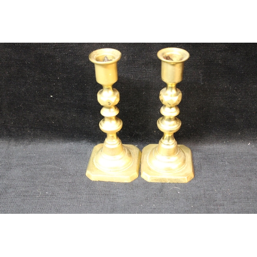 132 - A small pair of brass candlesticks - 15cmH