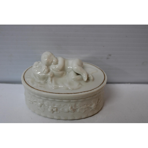 405 - A Belleek sleeping baby lidded pot 12cmw X 8cmH, blue mark