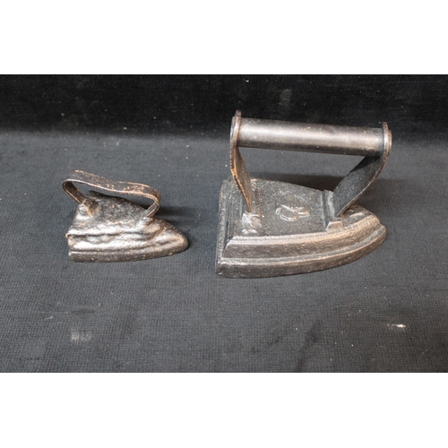 133 - Two cast iron smoothing irons - 14cm x 12cmH largest