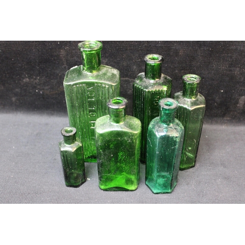 136 - Six green glass chemists bottles