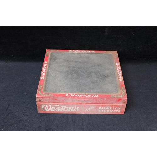 215 - A Weston's biscuit tin lid - 22cm x 23.5cm x 6cm