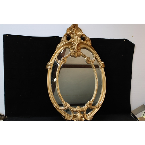 244 - An oval gilt framed Victorian style mirror - 103cmH