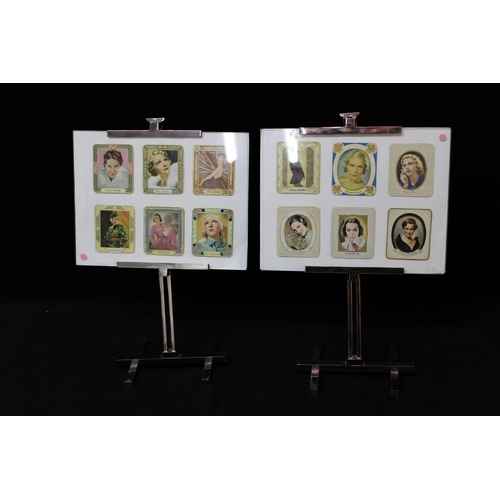 58 - Two small easels with photographs each 33cmH