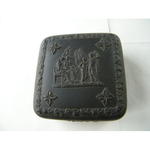318 - A Wedgwood black basalt relief moulded trinket box - 9.5.cm x 9.5cm x 5cm