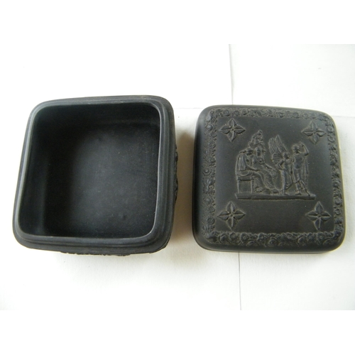 318 - A Wedgwood black basalt relief moulded trinket box - 9.5.cm x 9.5cm x 5cm